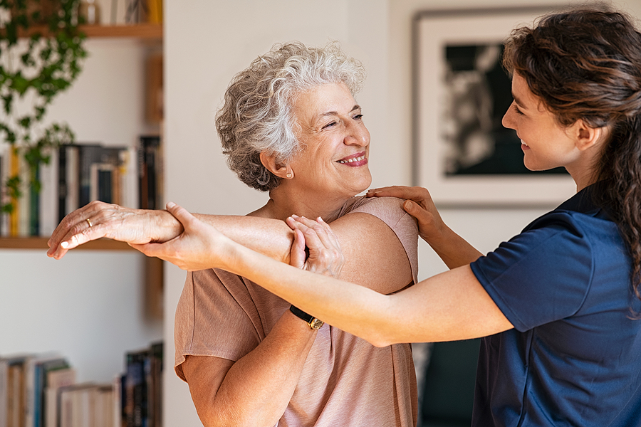 Senior woman working with a nurse in a rehabilitation facility